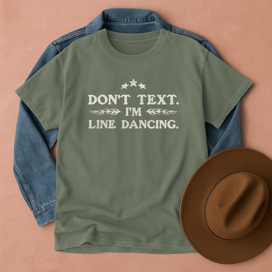 Green t-shirt with 'Don't Text. I'm Line Dancing' text, front view