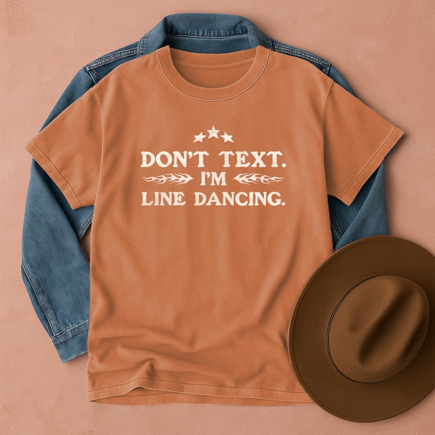 Brown t-shirt with Don't Text. I'm Line Dancing text, front view