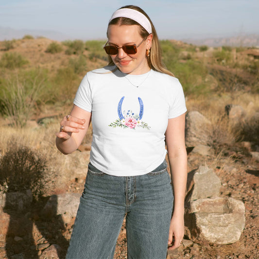 Woman wearing a white t-shirt with a graphic design outdoors in a desert setting