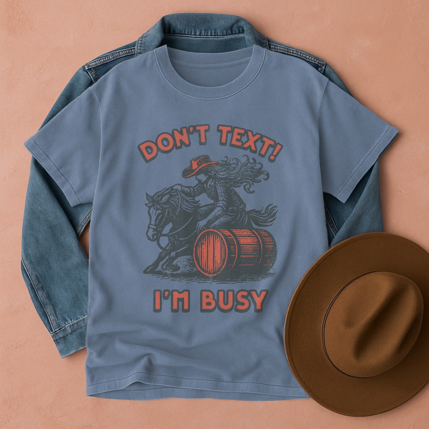Comfort Colors T-shirt with graphic design featuring a cowgirl on a horse barrel racing, Front view