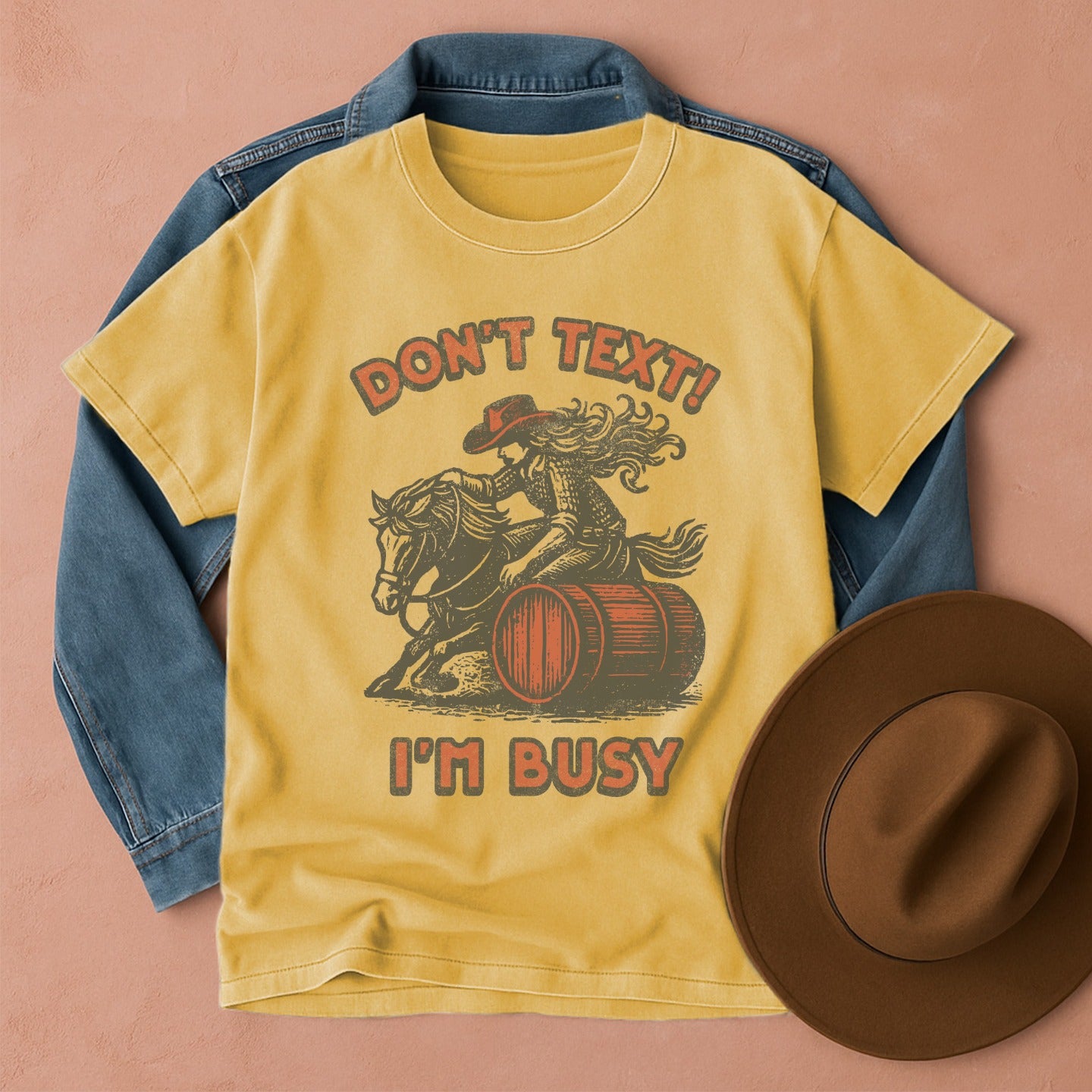 Comfort Colors T-shirt with graphic design featuring a cowgirl on a horse barrel racing, Front view
