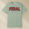 Light green t-shirt with 'FERAL FEMINIST' text on a beige background