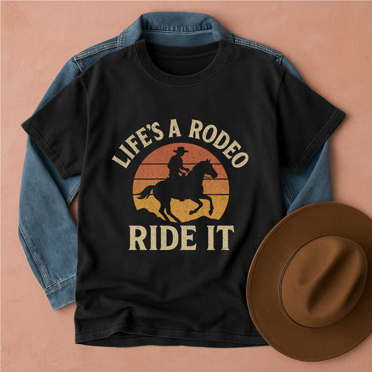 Black t-shirt with 'Life's a Rodeo, Ride It' graphic on a beige background